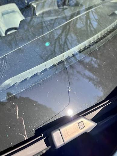 Long crack across windshield glass