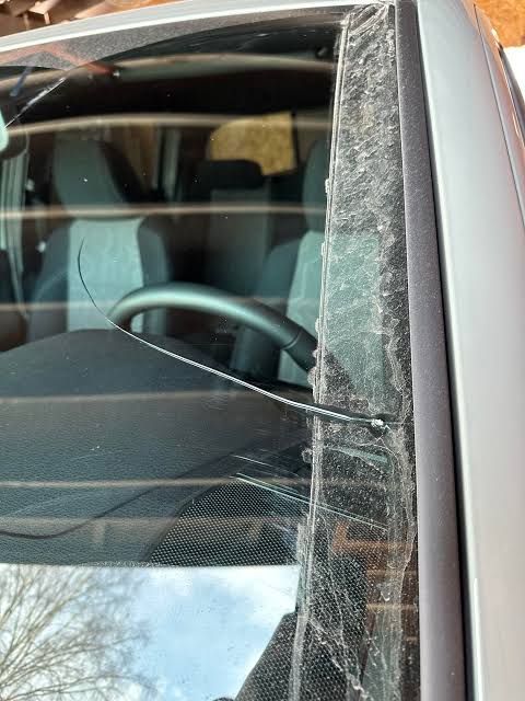 Edge chip with spreading crack on windshield glass requiring replacement